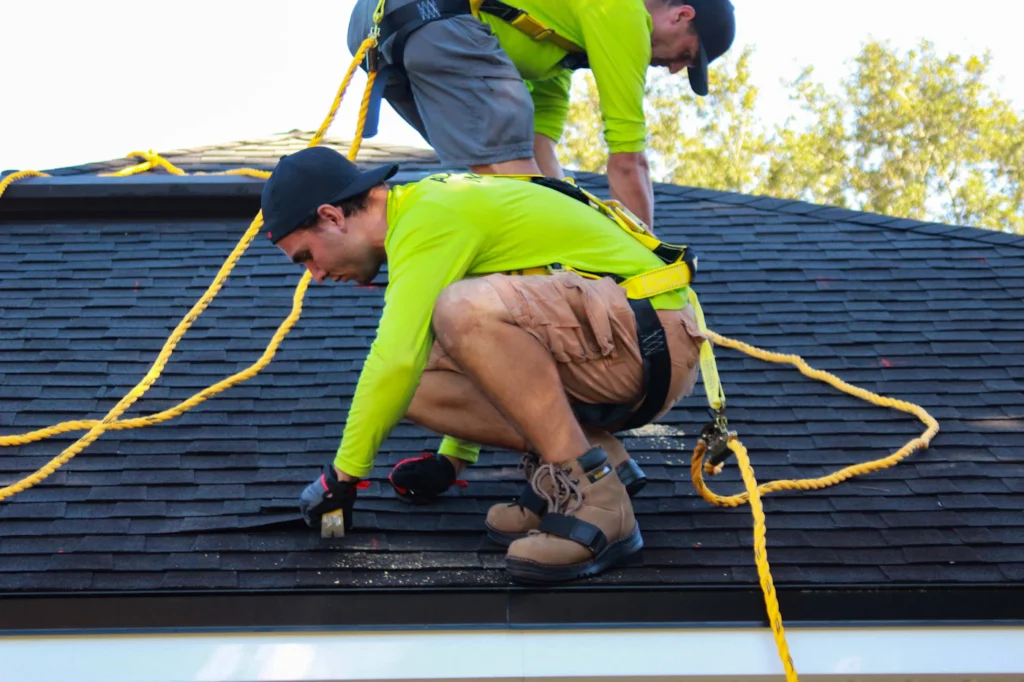 Crew installing asphalt shingles