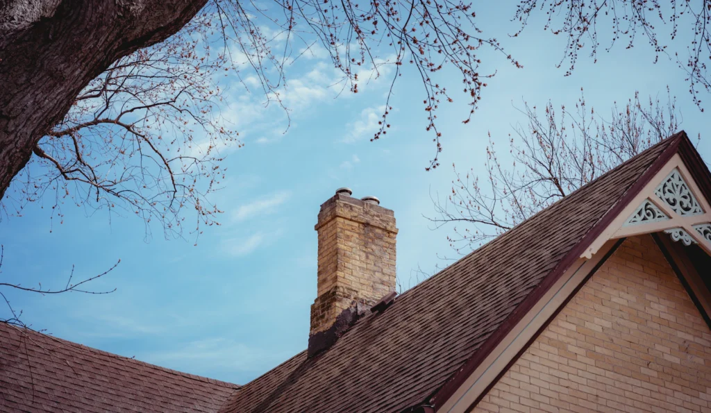 Brick chimney rising above a residential roof