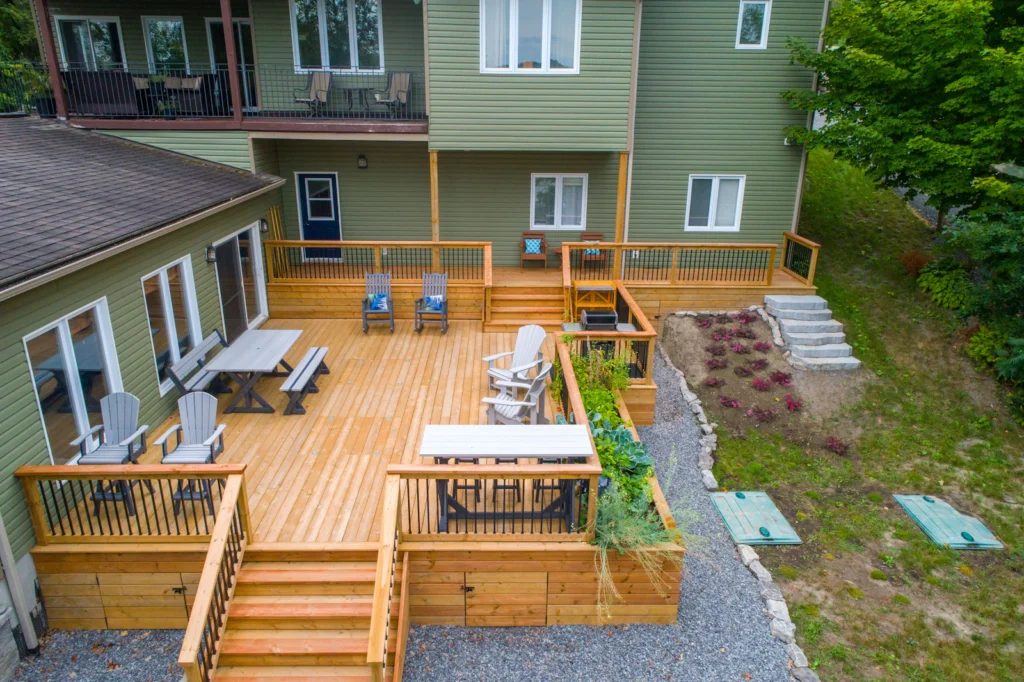 Wood deck with stairs leading down to a lawn