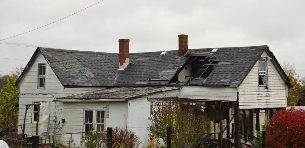 Storm debris and damage around a house
